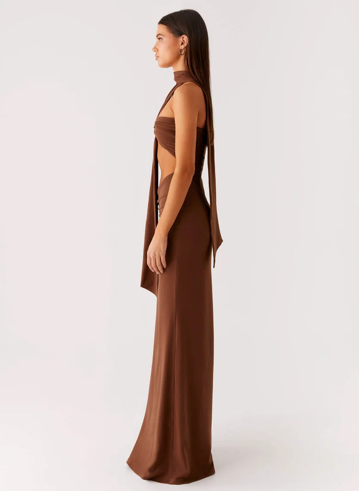 Woman wearing brown halter maxi dress with open back cutout detail — Peppermayo | Endless UAE