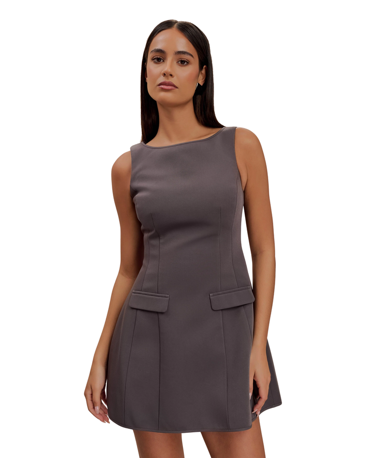 Woman wearing charcoal sleeveless suiting mini dress with front pockets and black platform heels — Meshki | Endless UAE