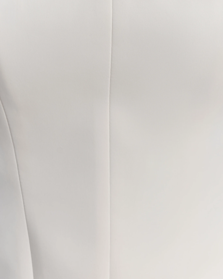 Woman wearing white strapless scuba corset with structured bodice and ruched detail — Meshki | Endless UAE
