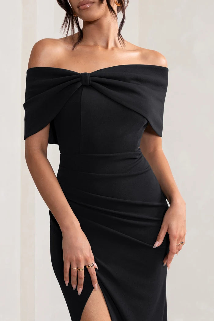 Woman wearing black off-shoulder maxi dress with bow detail from back view — Club L London | Endless UAE