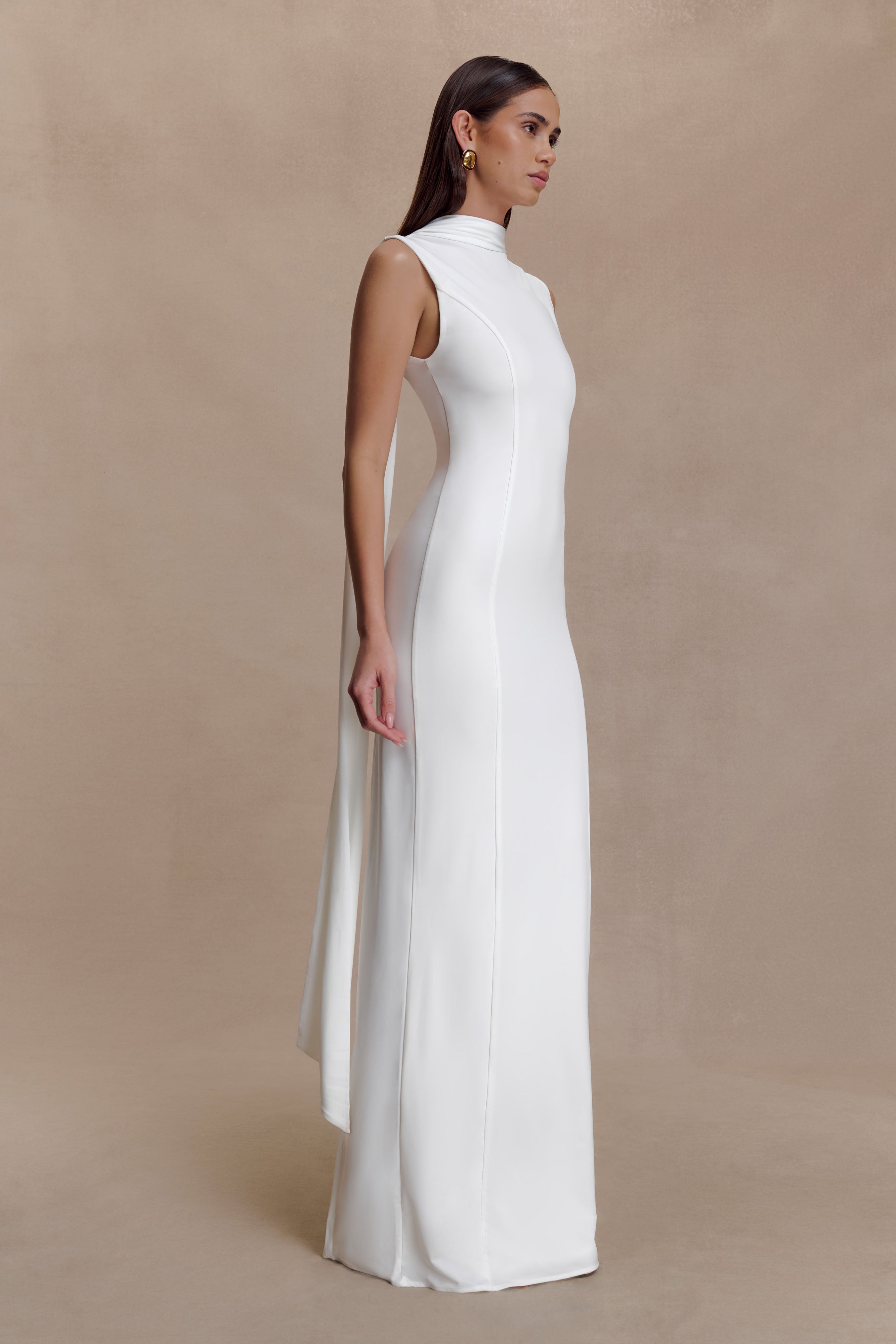 Woman modeling white sleeveless turtleneck maxi dress with flowing fabric — Meshki | Endless UAE