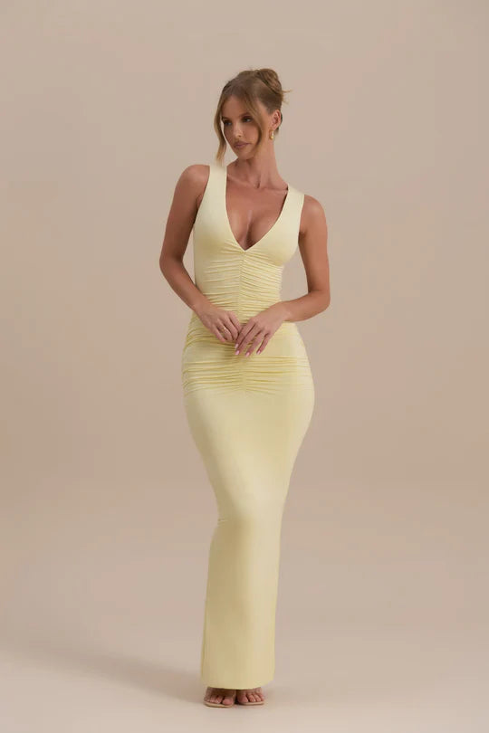 Woman wearing a pale yellow sleeveless maxi dress with ruched detailing — Wanderdoll | Endless UAE