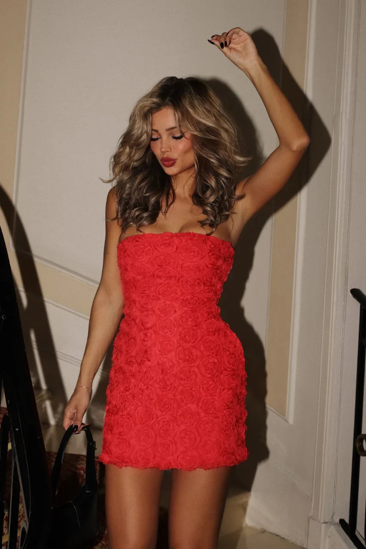 Woman wearing red rosette textured strapless mini dress against modern white architecture — Meshki | Endless UAE