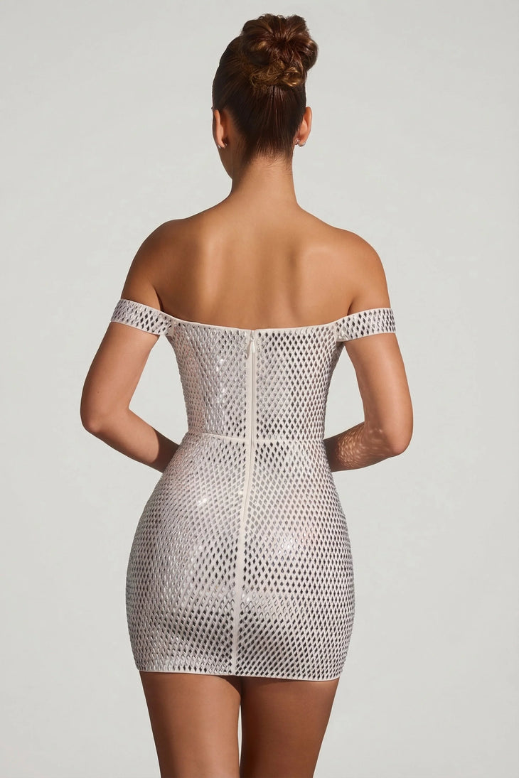 Woman wearing white embellished off-shoulder mini dress with metallic heels — Oh Polly | Endless UAE