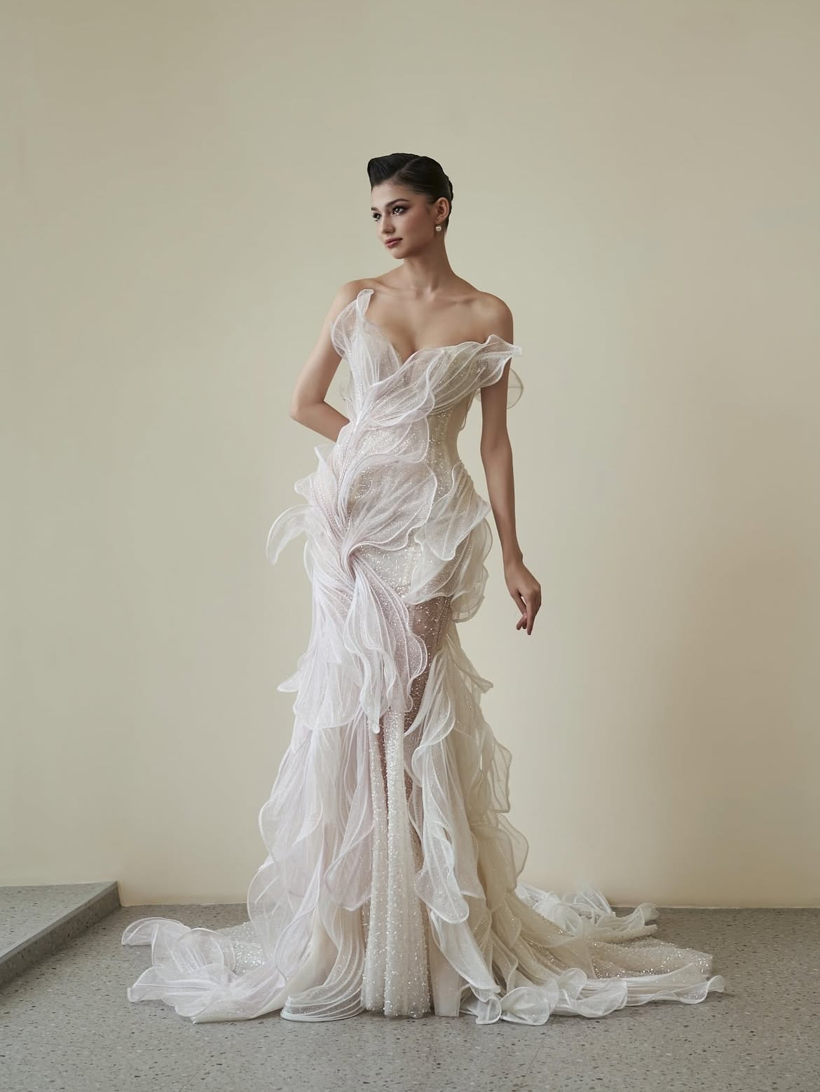Ethereal off-shoulder gown with layered tulle and beaded embellishments in ivory — HACCHIC | Endless UAE