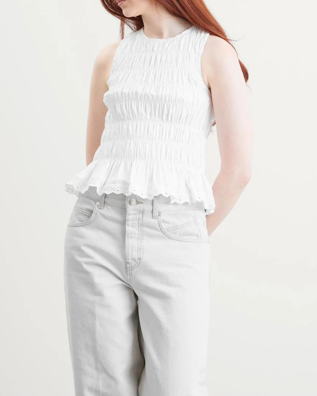 White ruched sleeveless top with lace hem paired with light denim jeans — Faithful The Brand | Endless UAE