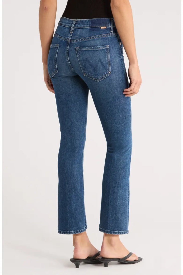 Woman wearing blue denim ankle bootcut jeans with black sandals — Mother | Endless UAE