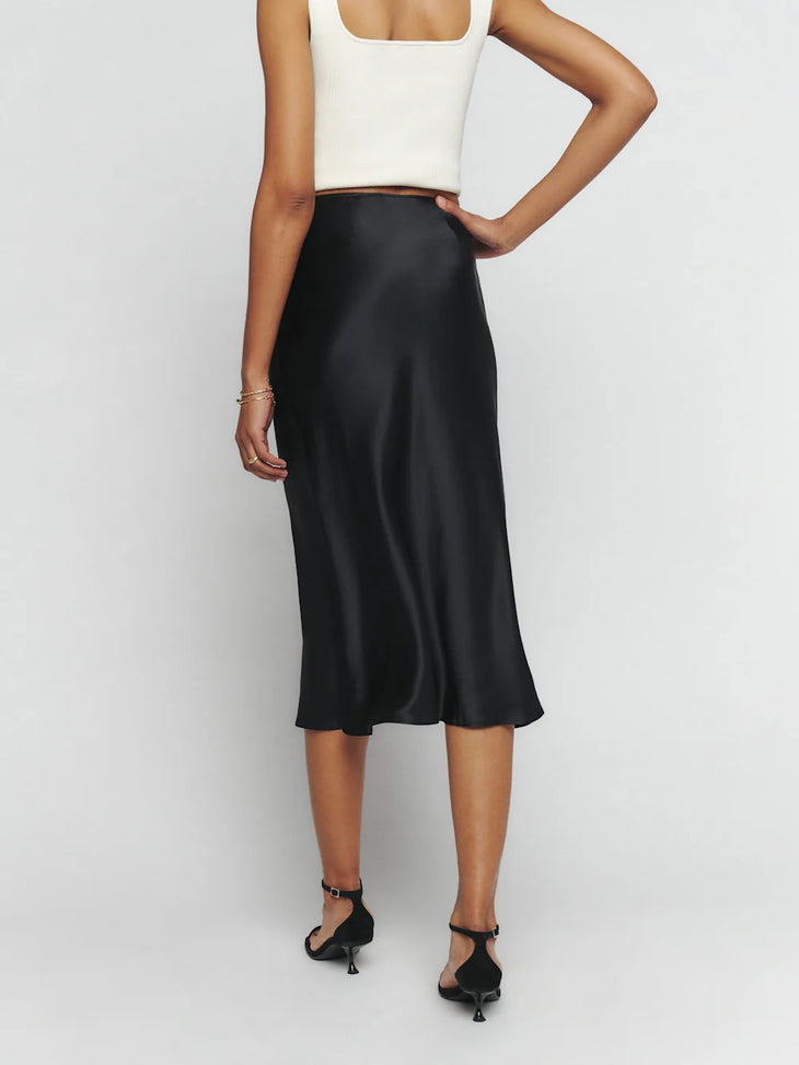 Black silk midi skirt with white crop tank top and black platform sandals — Reformation | Endless UAE