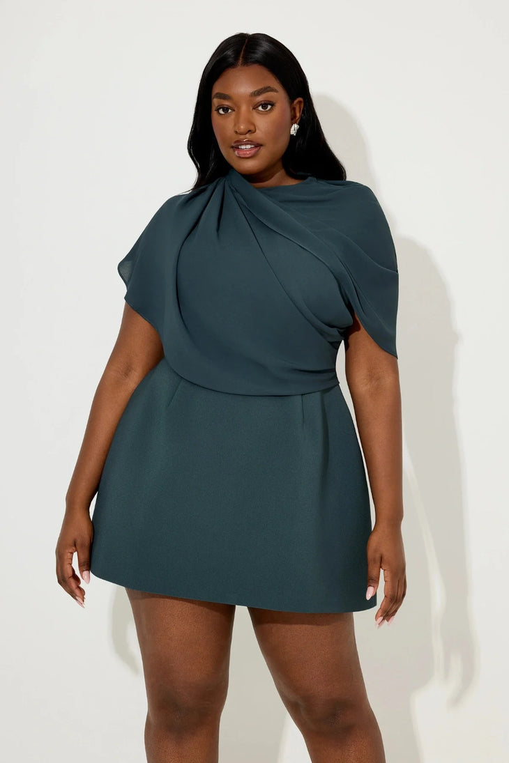 Woman wearing teal gathered mini dress with draped cape detail and white sandals — Aaizel11 | Endless UAE
