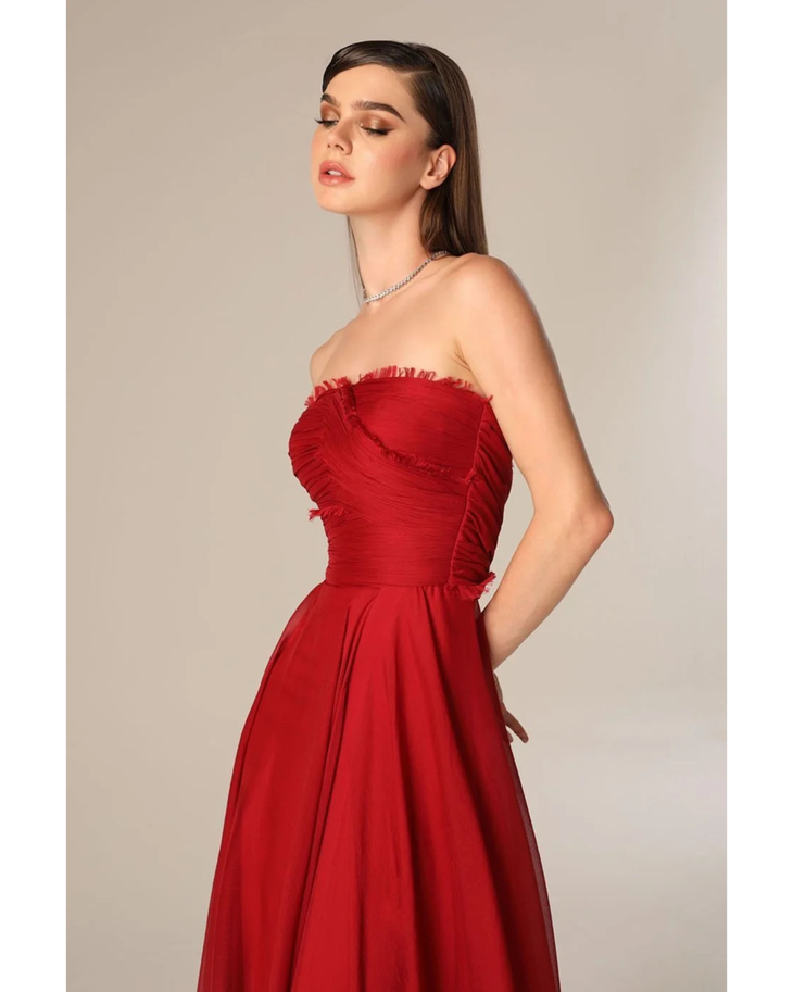 Woman wearing deep red strapless flowing gown with draped train — Velvety Couture | Endless UAE