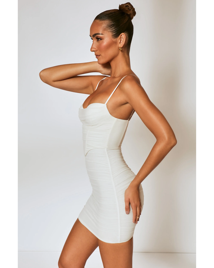 Woman wearing white ruched corset mini dress with spaghetti straps — Oh Polly | Endless UAE