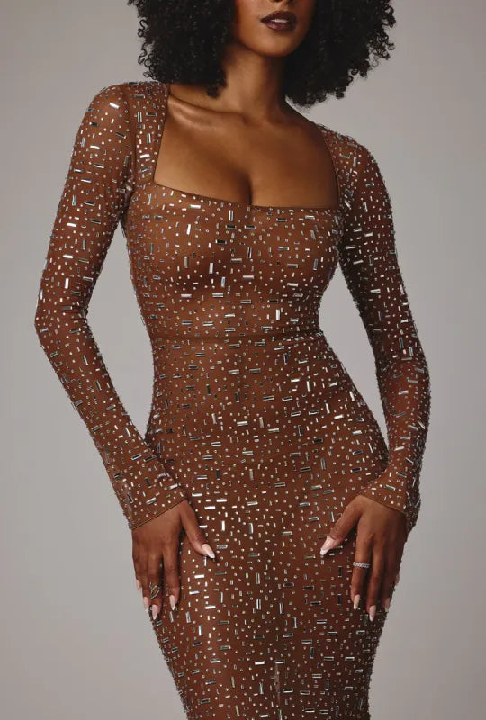Woman wearing bronze sequined long sleeve evening gown with plunging neckline — Oh Polly | Endless UAE
