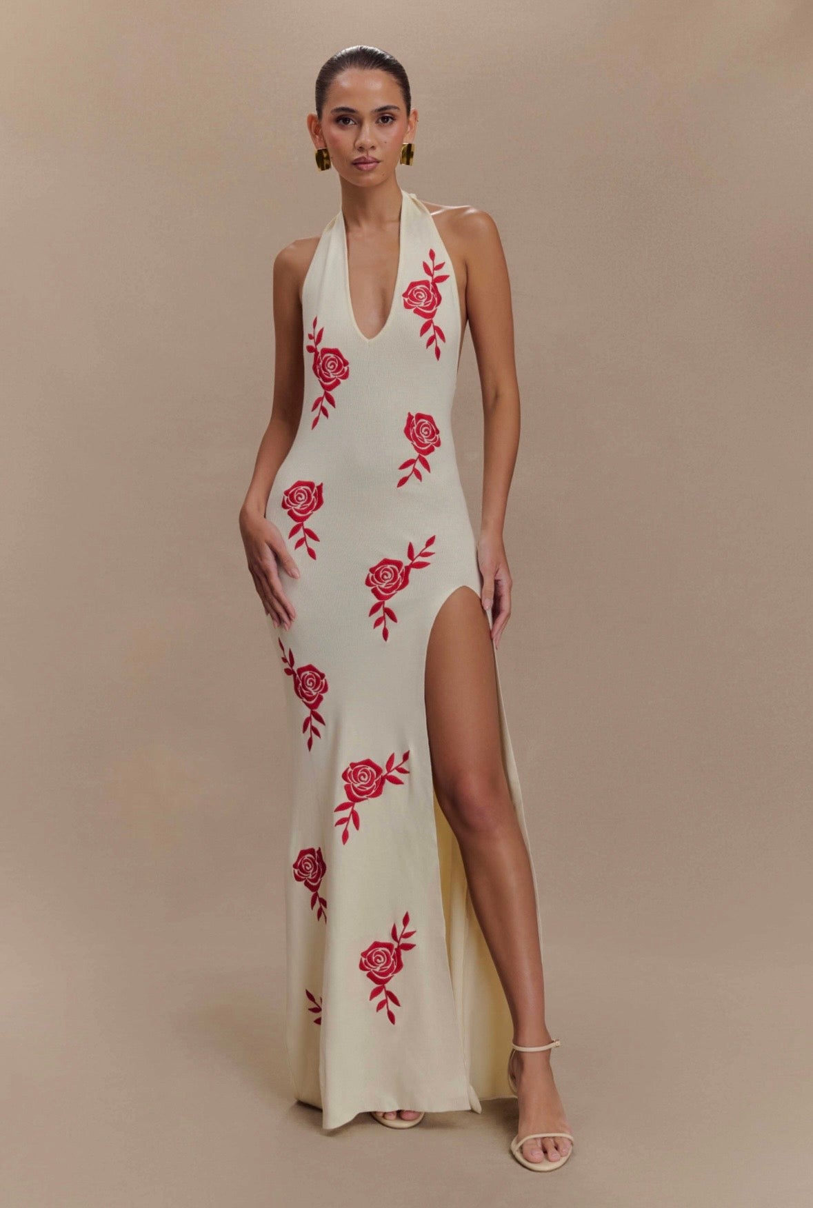 Woman wearing cream halter maxi dress with red rose embroidery and high slit — Meshki | Endless UAE