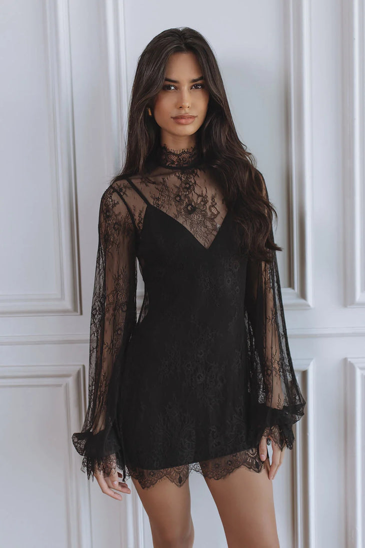 Woman wearing black lace mini dress with sheer long sleeves — Chic Le Frique | Endless UAE