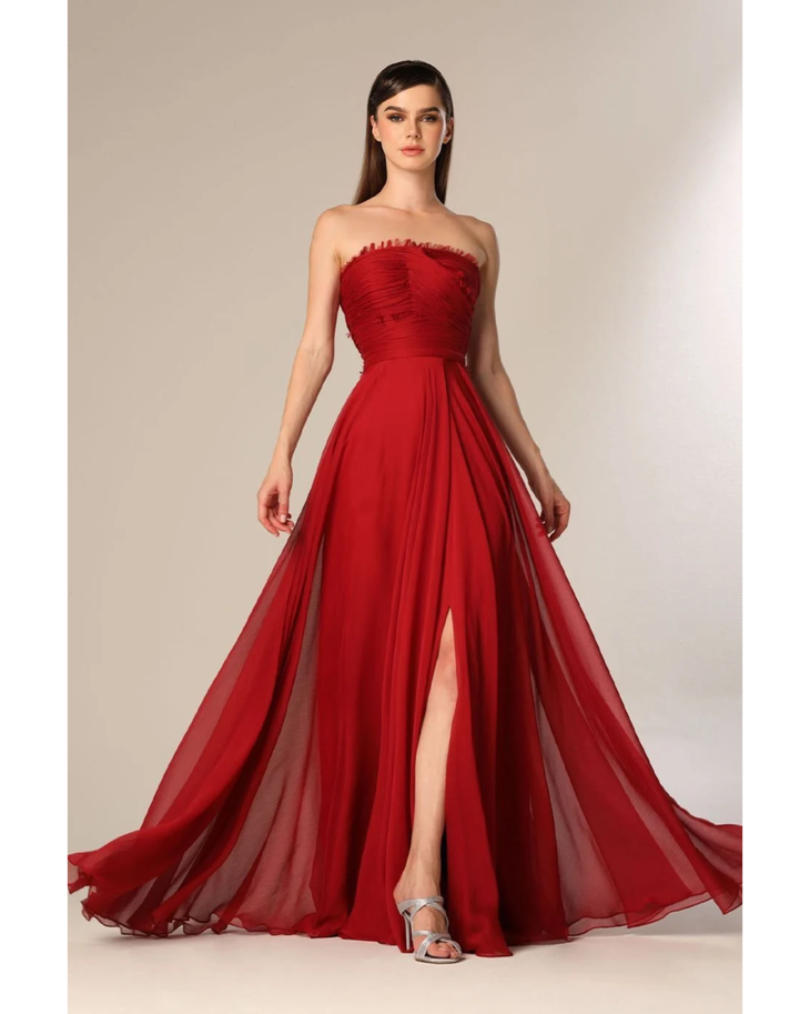 Woman wearing deep red strapless flowing gown with draped train — Velvety Couture | Endless UAE
