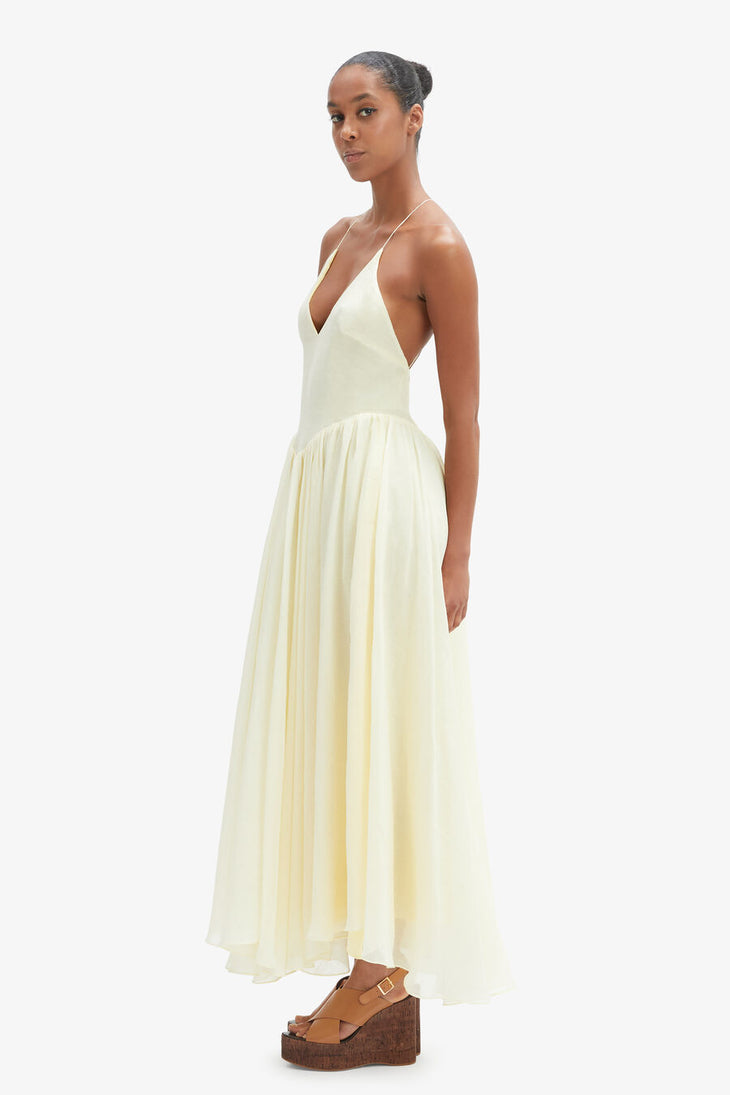 Woman wearing cream halter maxi dress with full skirt and wooden platform sandals — Bardot | Endless UAE