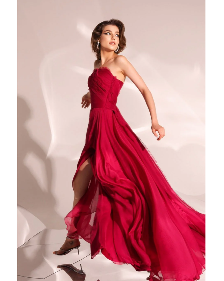 Woman wearing deep red strapless flowing gown with draped train — Velvety Couture | Endless UAE