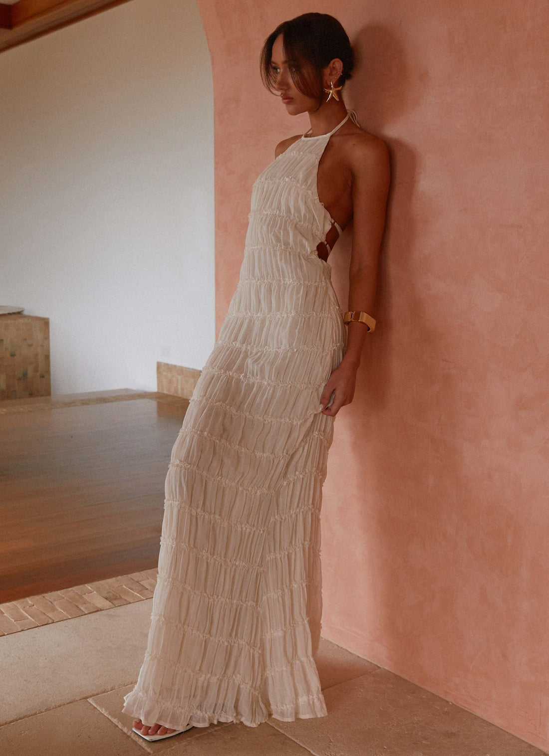 Woman wearing white pleated halter maxi dress in modern interior space — Peppermayo | Endless UAE