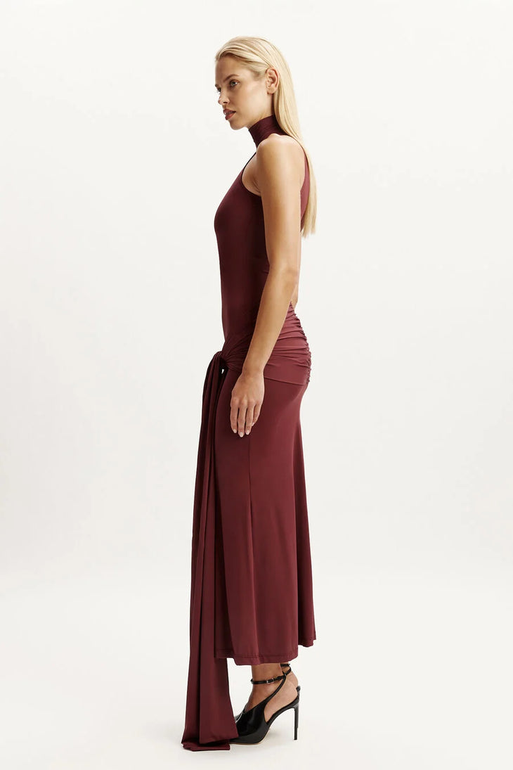 Woman wearing burgundy halterneck maxi dress with front tie detail — Chic Le Frique | Endless UAE