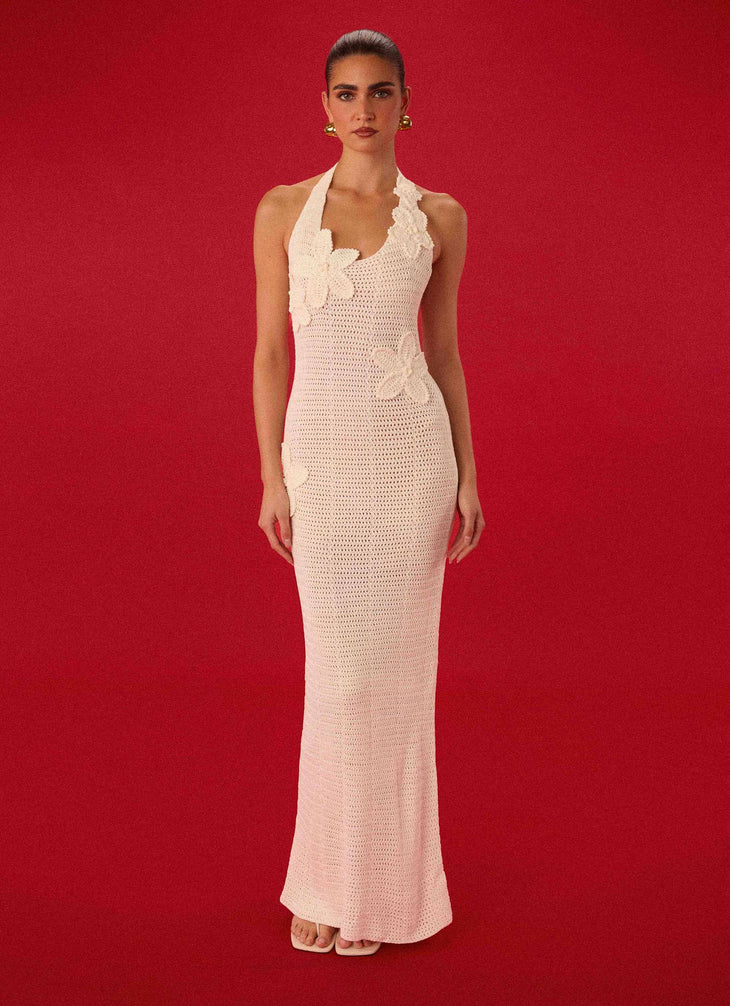 Woman wearing cream crochet halter maxi dress with floral appliqués — Peppermayo | Endless UAE