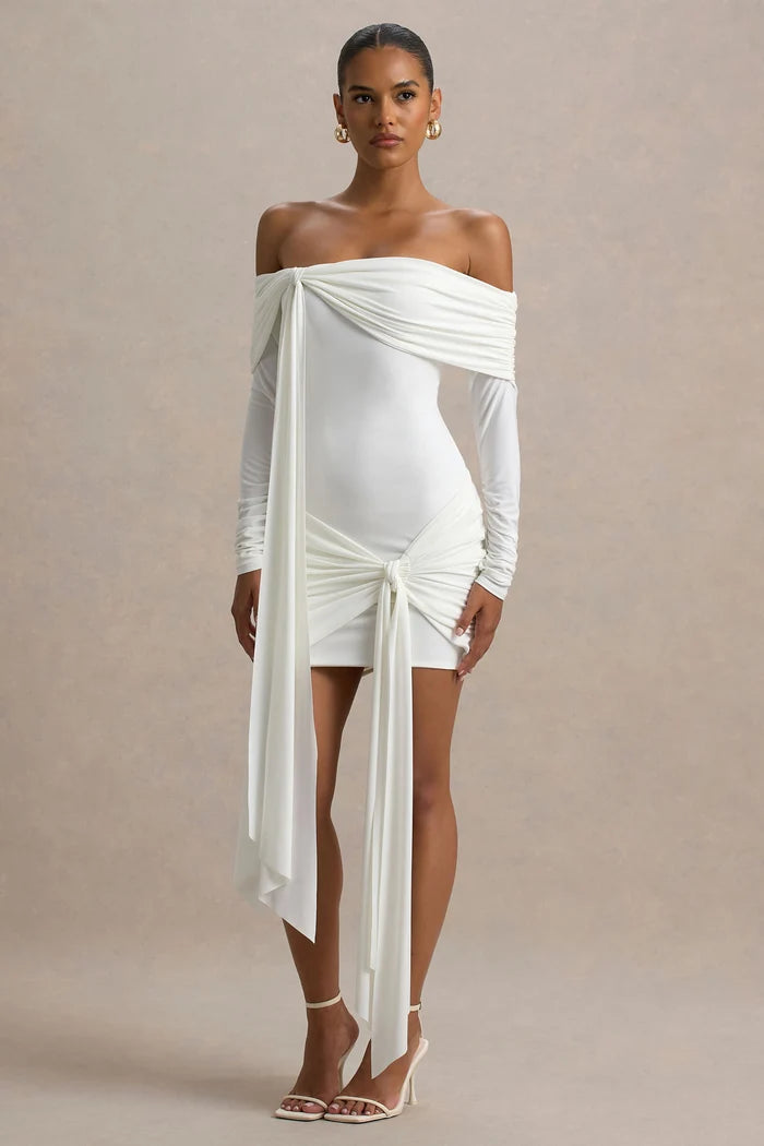 Woman wearing white Bardot wrap mini dress with off-shoulder design and long sleeves — Club L London | Endless UAE