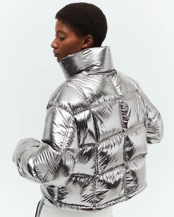 Model wearing metallic silver puffer jacket and matching pants against white background — Perfect moment | Endless UAE