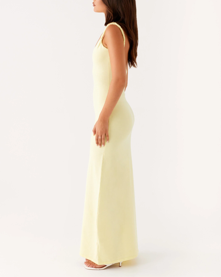 Woman wearing pale yellow sleeveless maxi dress with open back — Peppermayo | Endless UAE