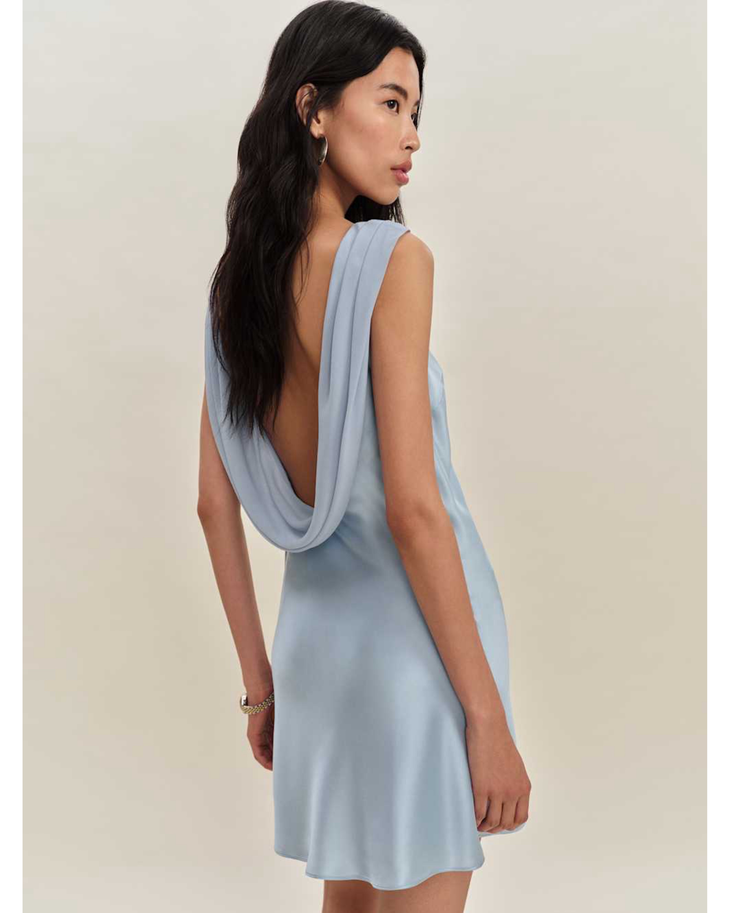 Woman wearing a light blue sleeveless silk dress with draped neckline — Reformation | Endless UAE