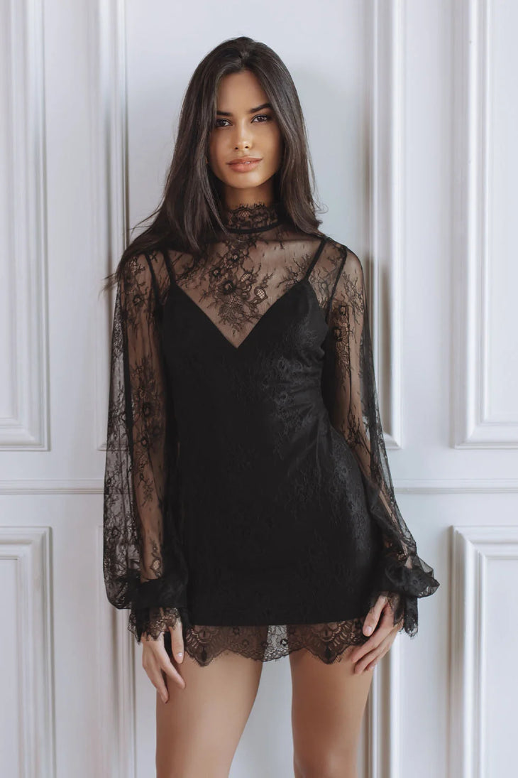 Woman wearing black lace mini dress with sheer long sleeves — Chic Le Frique | Endless UAE