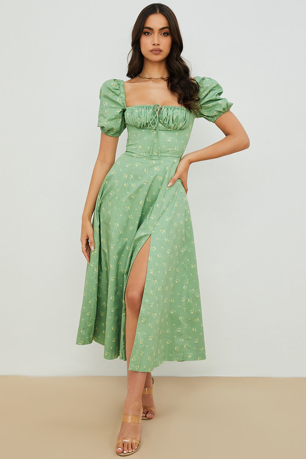 Woman wearing a green floral puff sleeve midi dress with a slit — House of CB | Endless UAE