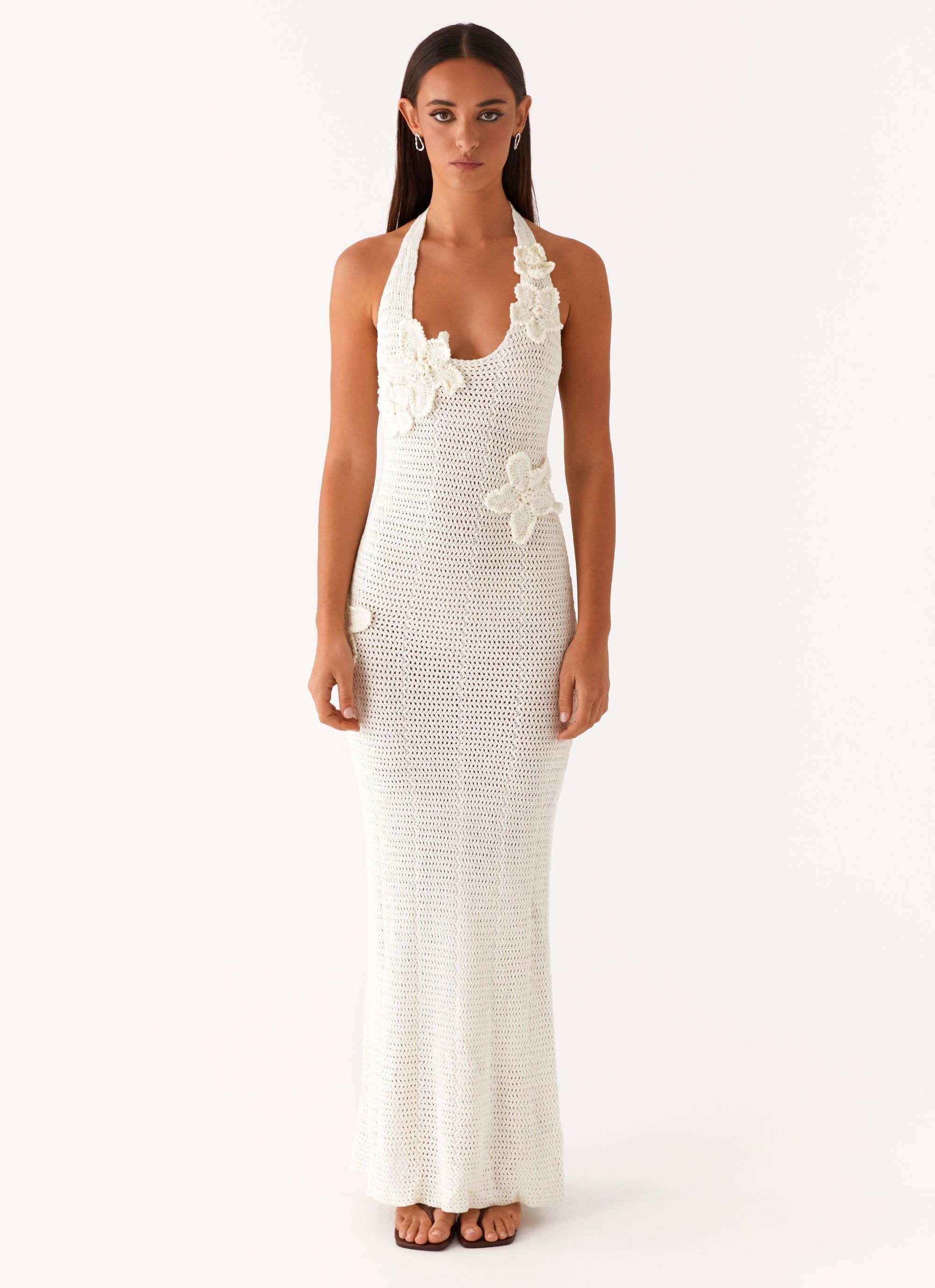Woman wearing cream crochet halter maxi dress with floral appliqués — Peppermayo | Endless UAE