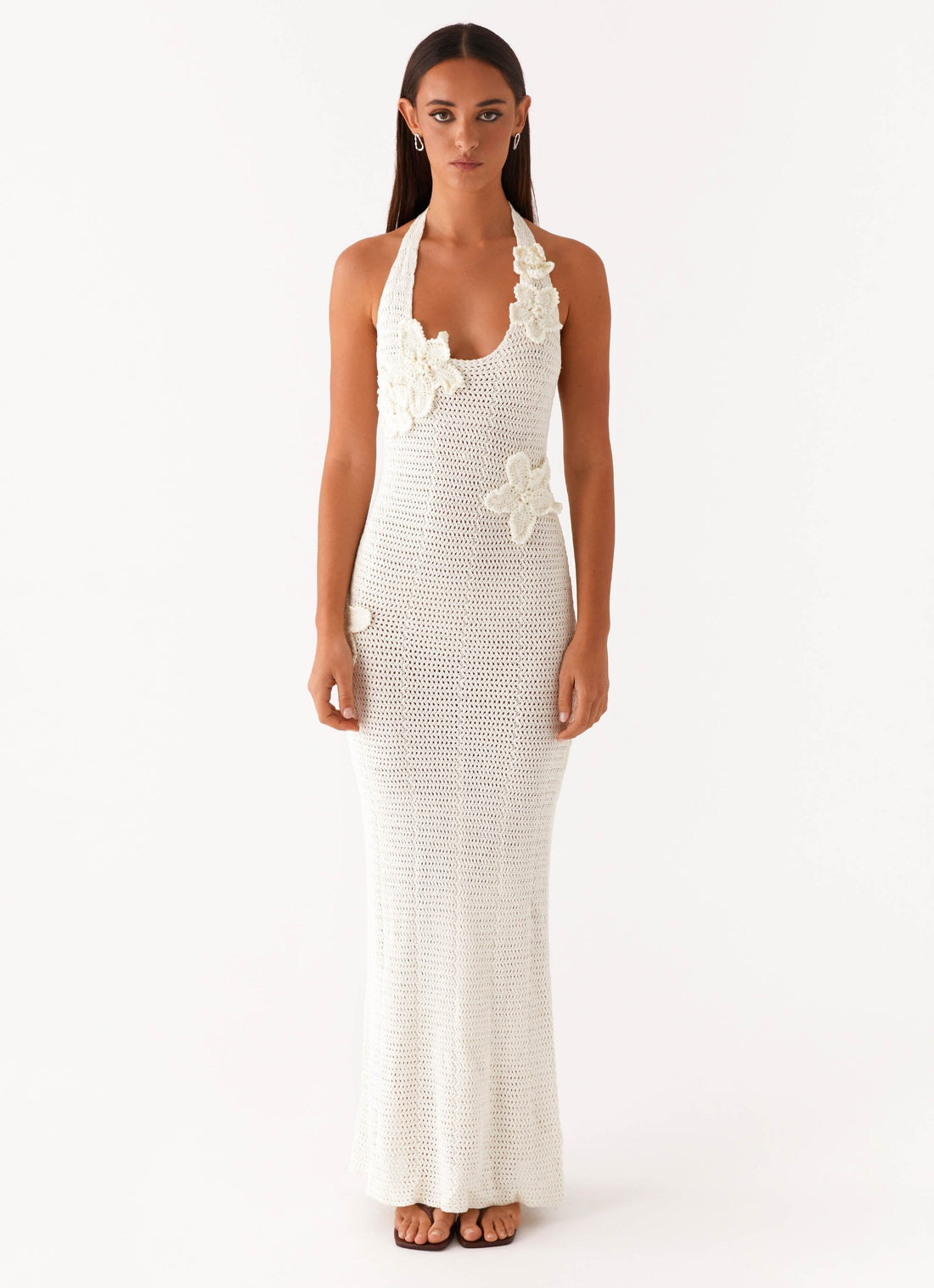 Woman wearing cream crochet halter maxi dress with floral appliqués — Peppermayo | Endless UAE