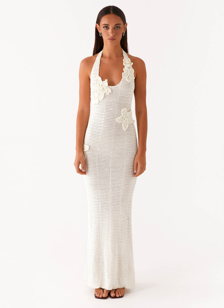 Woman wearing cream crochet halter maxi dress with floral appliqués — Peppermayo | Endless UAE