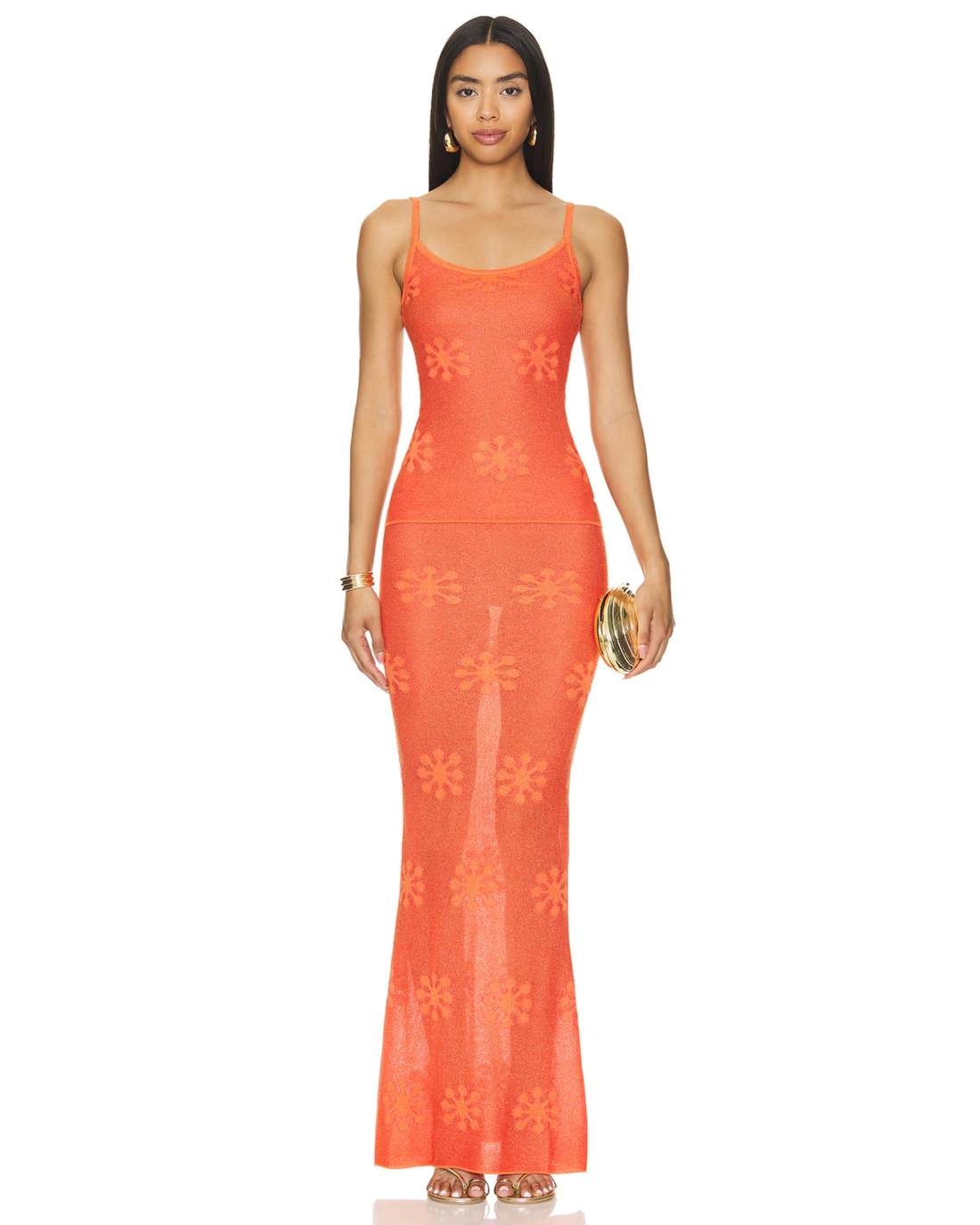 Woman wearing sunset orange crochet maxi dress with floral pattern and thin straps — Asta Resort | Endless UAE