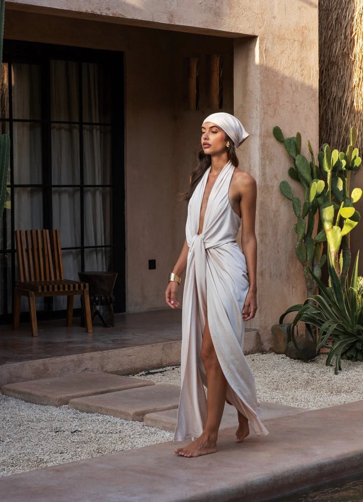 The Amalfi Gown in cream features a plunging halter neckline and draped silhouette — Melissa Phair | Endless UAE