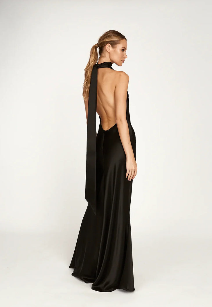 Woman wearing black halter satin gown with high slit and gold strappy heels — Sau Lee | Endless UAE