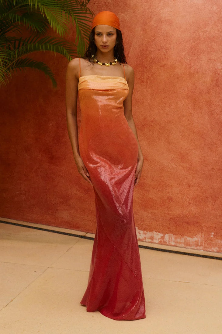 Woman wearing red ombre sequin strapless maxi dress against yellow wall — Bydee | Endless UAE