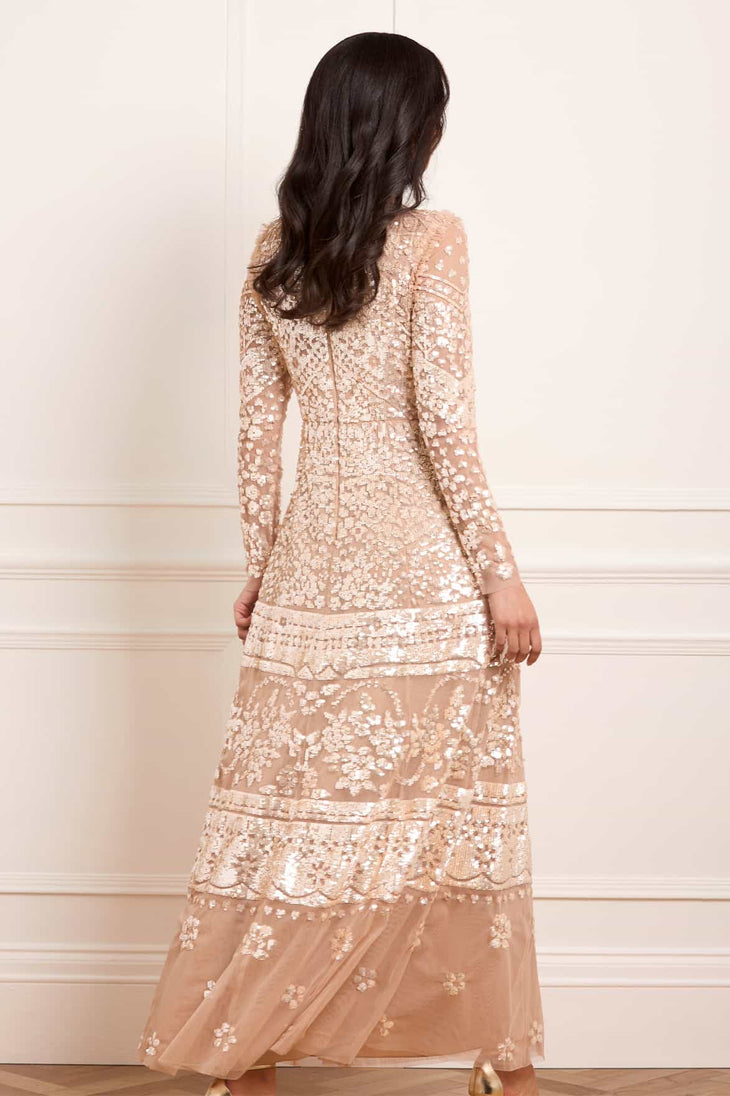 Woman wearing blush sequined Aurora Gown with long sleeves and tiered lace detailing — Needle & Thread | Endless UAE