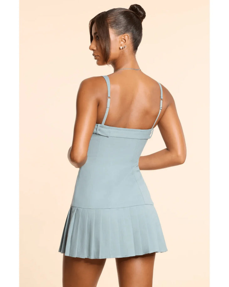 Woman wearing light blue sleeveless drop waist mini dress with pleated skirt detail — Oh Polly | Endless UAE