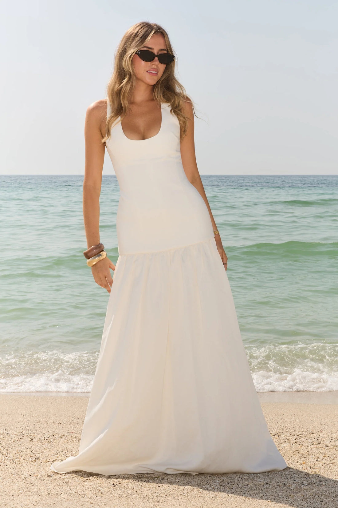 Woman wearing white linen mix dropped waist maxi dress on beach — Odd Muse | Endless UAE
