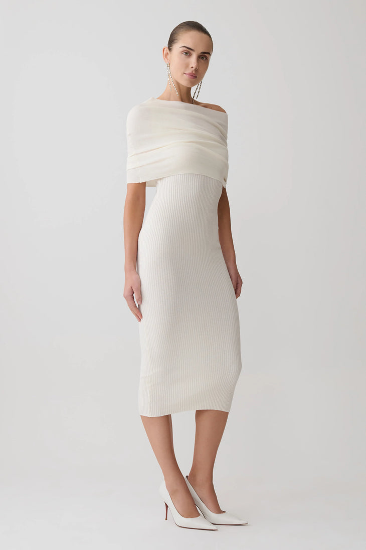 Woman wearing cream cashmere blend knit midi dress with draped off-shoulder overlay and white pointed heels — Meshki | Endless UAE