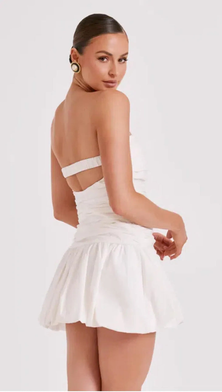 Woman wearing white strapless ruched cotton mini dress with circular earrings — Meshki | Endless UAE