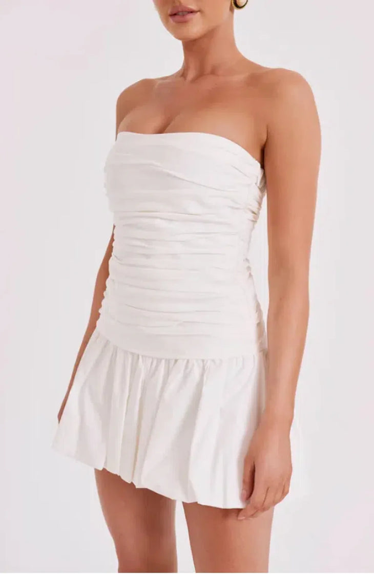 Woman wearing white strapless ruched cotton mini dress with circular earrings — Meshki | Endless UAE