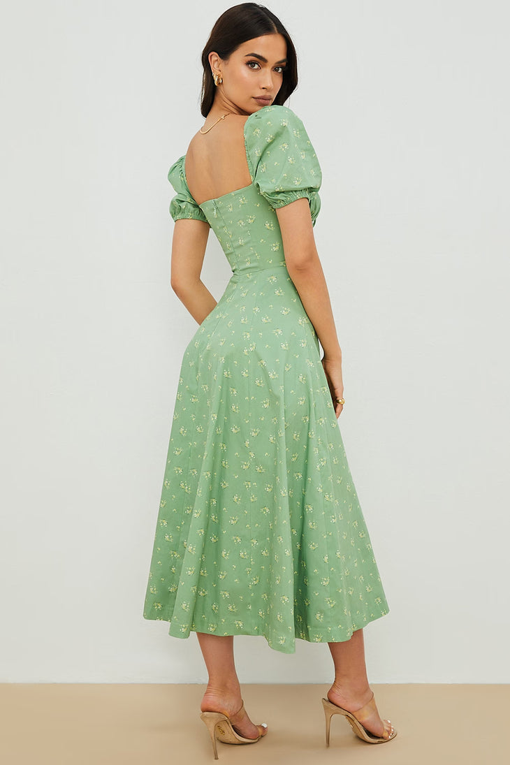 Woman wearing a green floral puff sleeve midi dress with a slit — House of CB | Endless UAE