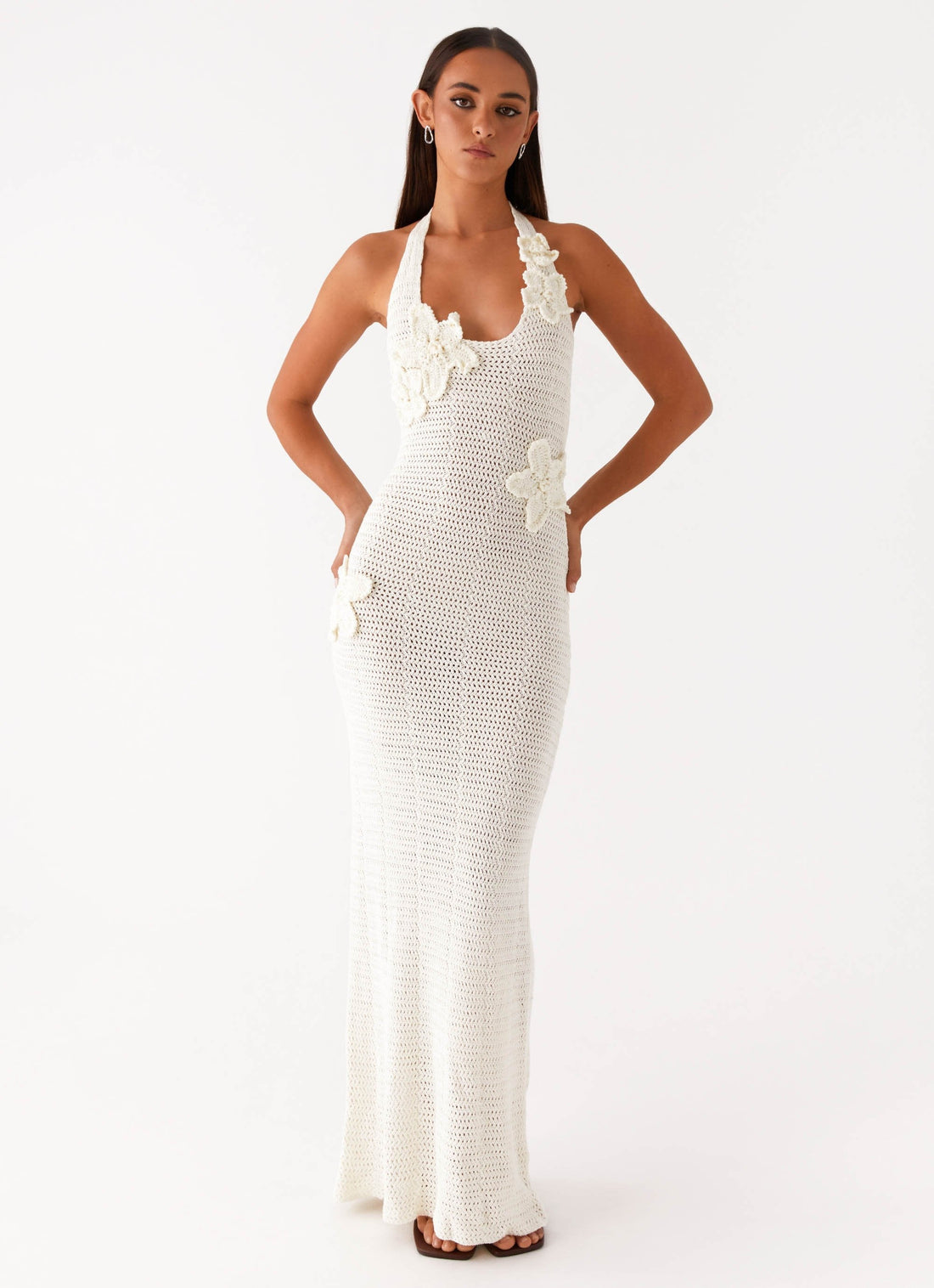 Woman wearing cream crochet halter maxi dress with floral appliqués — Peppermayo | Endless UAE