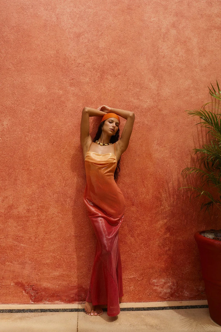 Woman wearing red ombre sequin strapless maxi dress against yellow wall — Bydee | Endless UAE