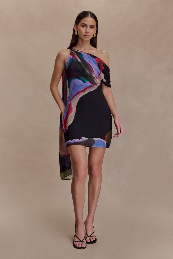 Woman wearing Daisie Chiffon Mini Dress in black with colorful abstract print drape — Meshki | Endless UAE