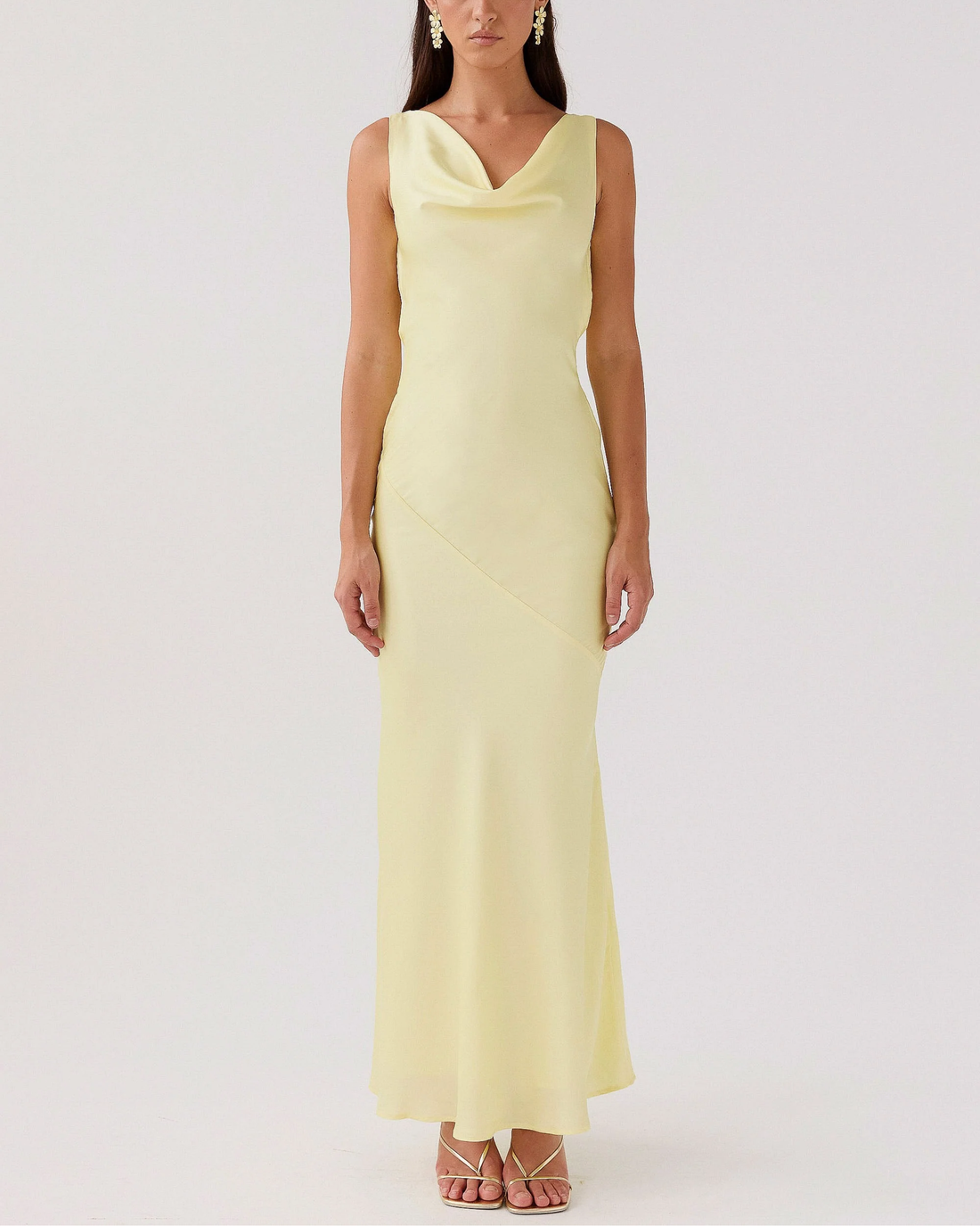 Woman wearing pale yellow satin sleeveless maxi dress with cowl neckline — Peppermayo | Endless UAE