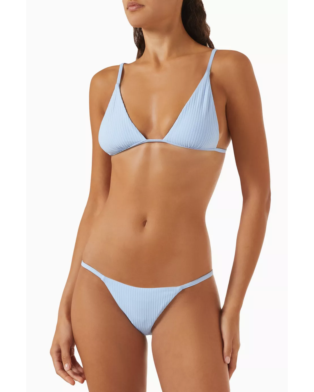 Woman wearing light blue ribbed triangle bikini top and matching bikini bottom — Monday Swimwear | Endless UAE