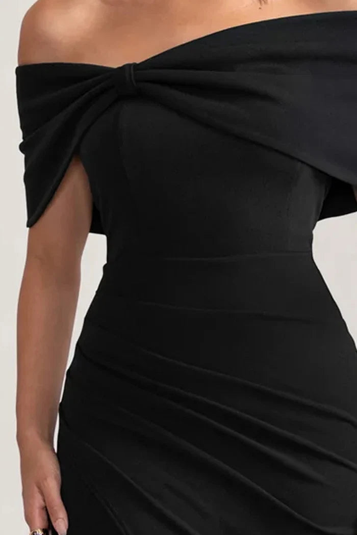 Woman wearing black off-shoulder maxi dress with bow detail from back view — Club L London | Endless UAE